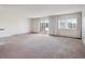 Spacious living room featuring carpet, large sliding glass door to balcony and large windows at 13618 E Bethany Pl # 306, Aurora, CO 80014