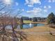 Picturesque view of a pond with a fountain, surrounded by a well-maintained golf course and trees at 13618 E Bethany Pl # 306, Aurora, CO 80014