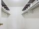Walk-in closet features built-in shelving and hanging rods for optimal storage at 13618 E Bethany Pl # 306, Aurora, CO 80014