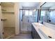 Modern bathroom features a double sink vanity and walk-in shower with glass door and marble-look tile at 5630 W 115Th Ave, Westminster, CO 80020
