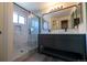 Modern bathroom features a double sink vanity and walk-in shower with glass door and marble-look tile at 5630 W 115Th Ave, Westminster, CO 80020