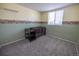 Bedroom with chair rail, neutral carpet, and a small crib setup near the large window at 5630 W 115Th Ave, Westminster, CO 80020