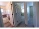 Hallway leads to full bathroom with shower over tub and adjacent carpeted bedroom with a large window at 5630 W 115Th Ave, Westminster, CO 80020