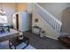 Inviting living room with dark hardwood floors, staircase, and adjacent dining area with large window at 5630 W 115Th Ave, Westminster, CO 80020