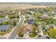 Charming neighborhood view with lush trees and well-maintained homes near open fields at 1535 Peach Ct, Brighton, CO 80601