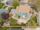 Aerial perspective of a home featuring a fenced yard, gardens and a paved sports court at 1535 Peach Ct, Brighton, CO 80601