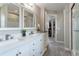 Beautifully renovated bathroom with double sinks, white cabinets, and modern fixtures at 1535 Peach Ct, Brighton, CO 80601