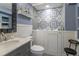 Well-lit bathroom featuring a walk-in tub and charming blue accents at 1535 Peach Ct, Brighton, CO 80601
