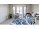 Bright bedroom with large bay window, chair, and daybed at 1535 Peach Ct, Brighton, CO 80601