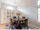 Bright dining room featuring a round table, hardwood floors, and a built-in cabinet at 1535 Peach Ct, Brighton, CO 80601