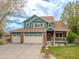 Charming two-story home with a three-car garage and inviting front porch at 1535 Peach Ct, Brighton, CO 80601