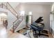 Open foyer with hardwood floors, staircase, and a black piano at 1535 Peach Ct, Brighton, CO 80601