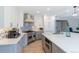 Spacious kitchen with white cabinetry, stainless steel appliances, and an island at 1535 Peach Ct, Brighton, CO 80601