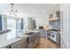 Bright kitchen featuring a large island, stainless steel appliances, and custom backsplash at 1535 Peach Ct, Brighton, CO 80601