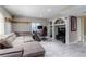 Spacious living room with a sectional couch, TV, and recessed lighting at 1535 Peach Ct, Brighton, CO 80601