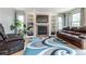 Cozy living room with built-in shelves, a fireplace, and comfortable leather furniture at 1535 Peach Ct, Brighton, CO 80601