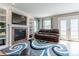 Comfortable living room with a fireplace, built-in shelves, and french doors to the backyard at 1535 Peach Ct, Brighton, CO 80601