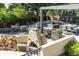 Multi-level patio with an outdoor kitchen, fire pit, and dining area, creating an inviting outdoor space at 4181 S Ivy Ln, Cherry Hills Village, CO 80111