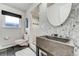 A modern bathroom showcases a stylish stone sink, sleek tile, and a glass-enclosed shower for a spa-like experience at 4181 S Ivy Ln, Cherry Hills Village, CO 80111