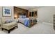 Bedroom with wood accent wall, comfy chair and blue bedding at 4181 S Ivy Ln, Cherry Hills Village, CO 80111