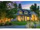 Charming two-story home with a well-manicured lawn and mature trees, creating a picturesque setting at 4181 S Ivy Ln, Cherry Hills Village, CO 80111