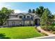 Charming two-story home featuring manicured front lawn and inviting brick walkway at 4181 S Ivy Ln, Cherry Hills Village, CO 80111