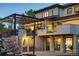 Back exterior of home showing outdoor living space, basketball court, and BBQ area at 4181 S Ivy Ln, Cherry Hills Village, CO 80111
