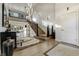 Bright foyer with hardwood floors, a modern staircase, and soaring ceilings offers an inviting entry at 4181 S Ivy Ln, Cherry Hills Village, CO 80111