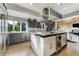 Bright kitchen with white and dark gray cabinets, featuring a large kitchen island at 4181 S Ivy Ln, Cherry Hills Village, CO 80111