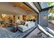 Bright living room with wood ceiling flows into a deck, offering an open concept at 4181 S Ivy Ln, Cherry Hills Village, CO 80111