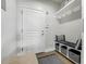A clean mudroom features a bench with storage baskets, hooks for hanging items, and an easy access exterior door at 4181 S Ivy Ln, Cherry Hills Village, CO 80111