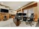 This stylish office features wood paneling, large windows, and a modern desk setup for a comfortable workspace at 4181 S Ivy Ln, Cherry Hills Village, CO 80111