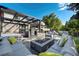 Outdoor living area with fire pit, comfortable seating, and pergola, perfect for entertaining at 4181 S Ivy Ln, Cherry Hills Village, CO 80111