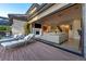 The outdoor deck with luxurious lounge seating transitions to the living room through sliding doors at 4181 S Ivy Ln, Cherry Hills Village, CO 80111