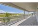 Covered balcony with white railing offering great views of the open landscape and distant mountains at 4769 Weitbrec Ln, Castle Rock, CO 80104