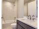Clean bathroom featuring a shower-tub combo with white tile and a vanity with white countertops at 4769 Weitbrec Ln, Castle Rock, CO 80104