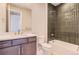 Modern bathroom featuring a sleek vanity, toilet, and shower-tub combination with stylish dark vertical tile at 4769 Weitbrec Ln, Castle Rock, CO 80104