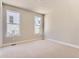 Neutral bedroom boasts two windows, plush carpet, and is bathed in plenty of natural light at 4769 Weitbrec Ln, Castle Rock, CO 80104