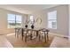Bright dining room with a large window view, featuring a natural wood table with seating for six under recessed lighting at 4769 Weitbrec Ln, Castle Rock, CO 80104