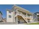 Back exterior showing a large covered deck, stairs leading to the yard, and ample natural light at 4769 Weitbrec Ln, Castle Rock, CO 80104