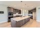 Spacious kitchen with dark wood cabinetry, a large island, stainless steel appliances, and plenty of natural light at 4769 Weitbrec Ln, Castle Rock, CO 80104