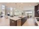 Open-concept kitchen featuring a large center island with a breakfast bar, stainless steel appliances, and natural light at 4769 Weitbrec Ln, Castle Rock, CO 80104