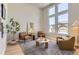 Stylish living room with high ceilings, a cozy seating area, and large windows providing natural light at 4769 Weitbrec Ln, Castle Rock, CO 80104