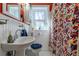 Vibrant bathroom features colorful shower curtain, white wainscoting, and bright lighting at 1436 N Gilpin St # 2, Denver, CO 80218