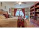 Spacious bedroom featuring hardwood floors, ceiling fan, and unique decorative accents at 1436 N Gilpin St # 2, Denver, CO 80218