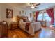 Comfortable bedroom features hardwood floors, ceiling fan and bright natural light at 1436 N Gilpin St # 2, Denver, CO 80218