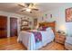 Inviting bedroom with hardwood floors, ceiling fan, and a comfortable queen-sized bed at 1436 N Gilpin St # 2, Denver, CO 80218