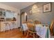 Stylish dining area with access to the kitchen featuring charming vintage decor and hardwood floors at 1436 N Gilpin St # 2, Denver, CO 80218