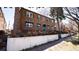 Beautiful brick home with a lush front yard, green awnings, and mature trees at 1436 N Gilpin St # 2, Denver, CO 80218