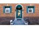 Charming brick home entrance with a glass paneled door, blue awning, and symmetrical windows at 1436 N Gilpin St # 2, Denver, CO 80218